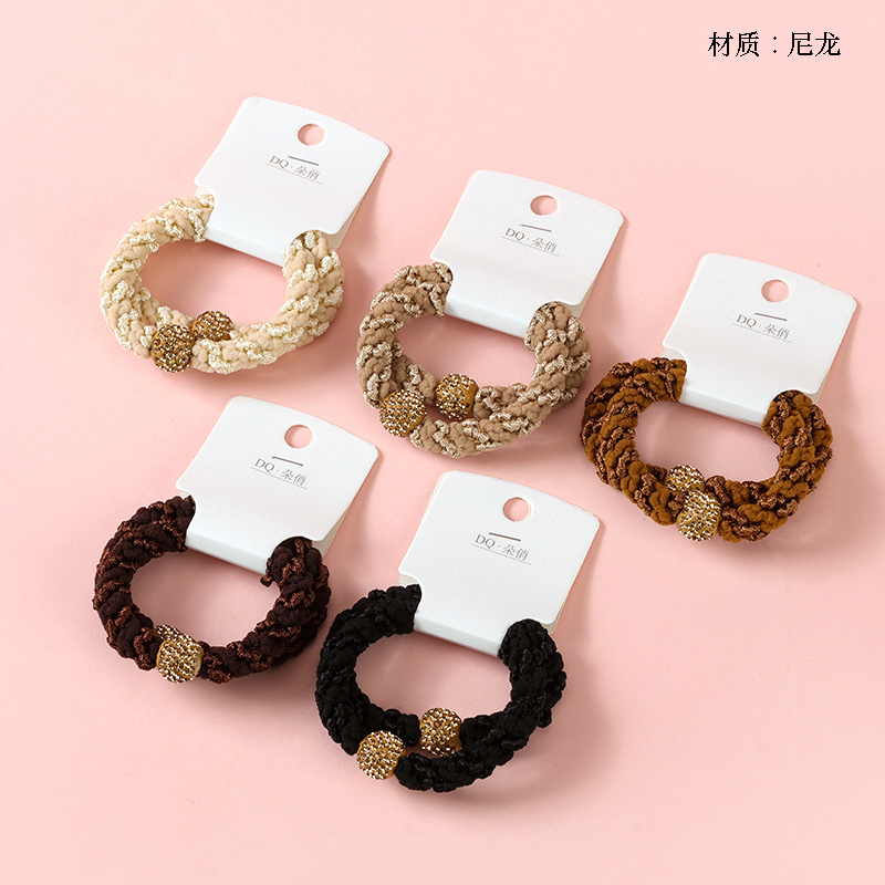 Two brown diamond ball accessories rubber bands