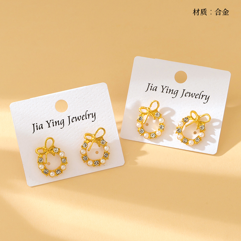 Long bow pearl stud earrings