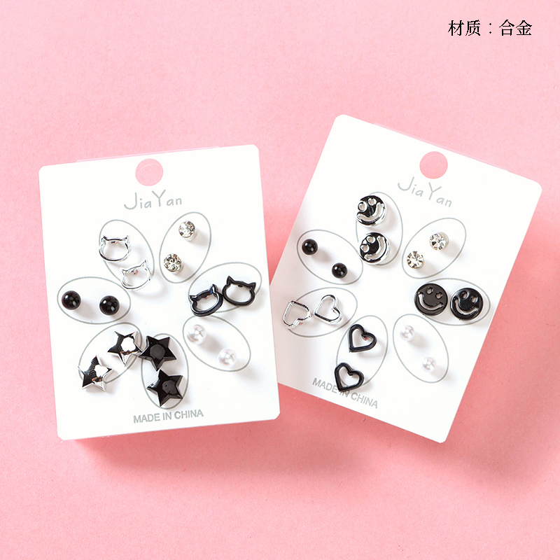Seven pairs of simple black silver stud earrings