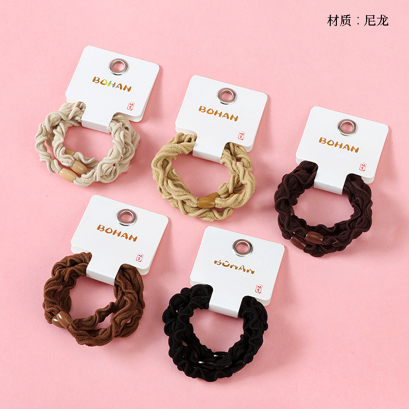 Boxed three curry colored wavy rubber bands