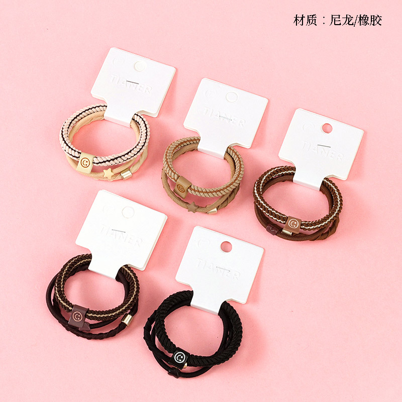 Three milk tea-colored smiley face labeled rubber bands