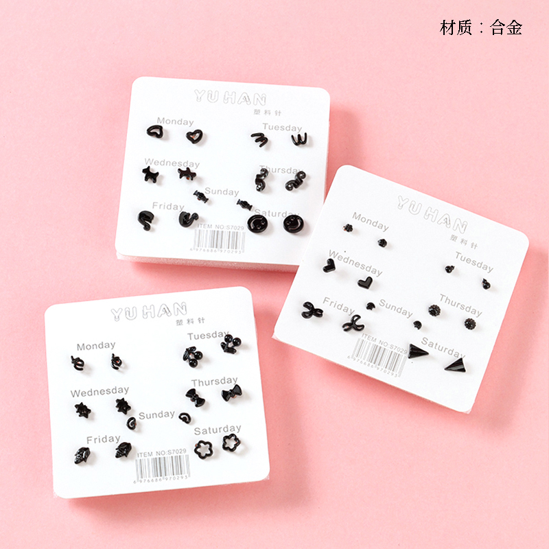 Seven pairs of simple black stud earrings