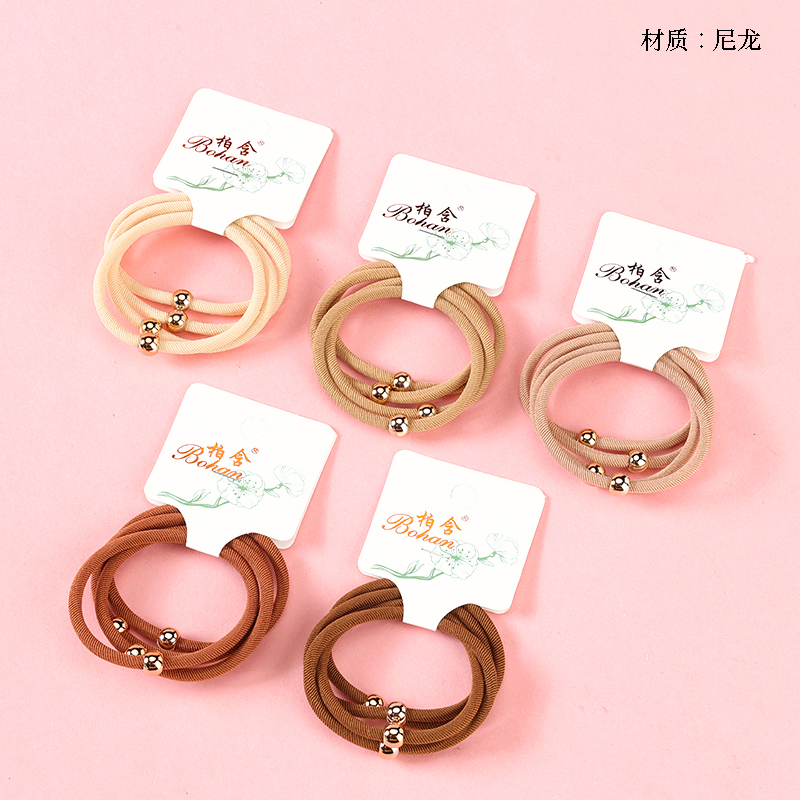 Boxed four gold beads twill rubber bands