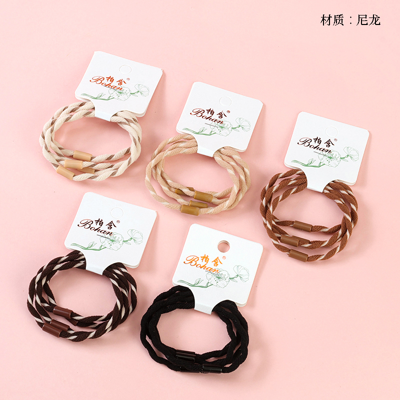 Boxed four curry colored wavy rubber bands