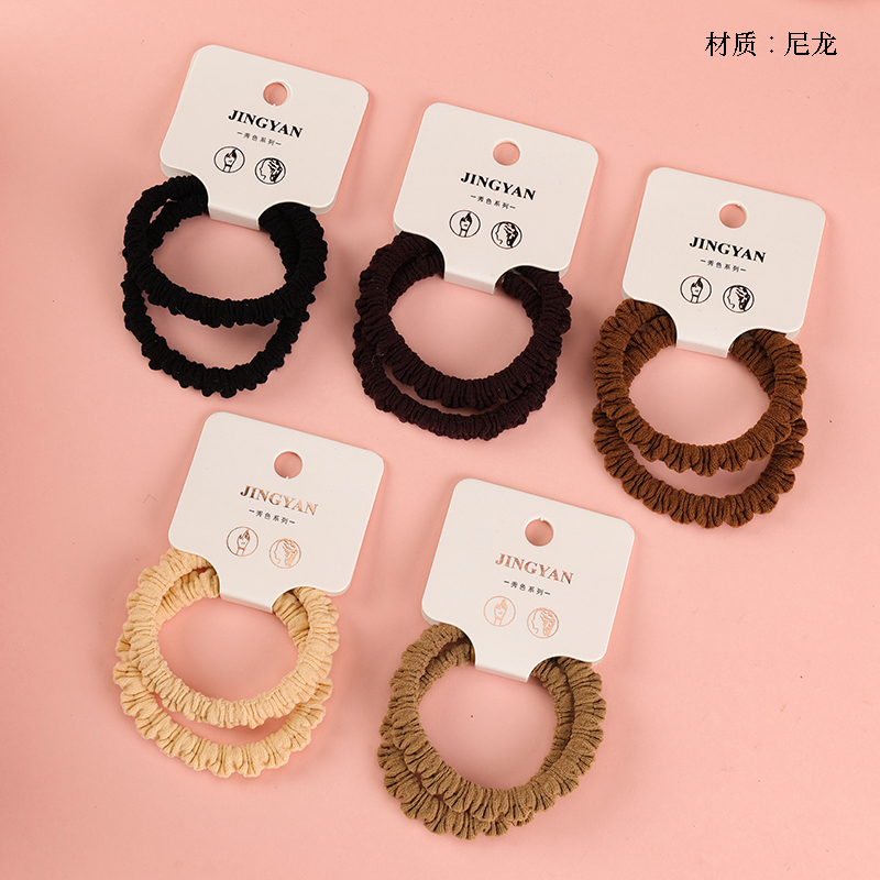 Boxed two curry-colored wood-ear-edged rubber bands