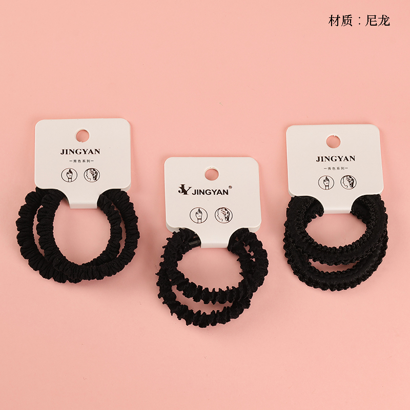 Boxed two crushed black rubber bands