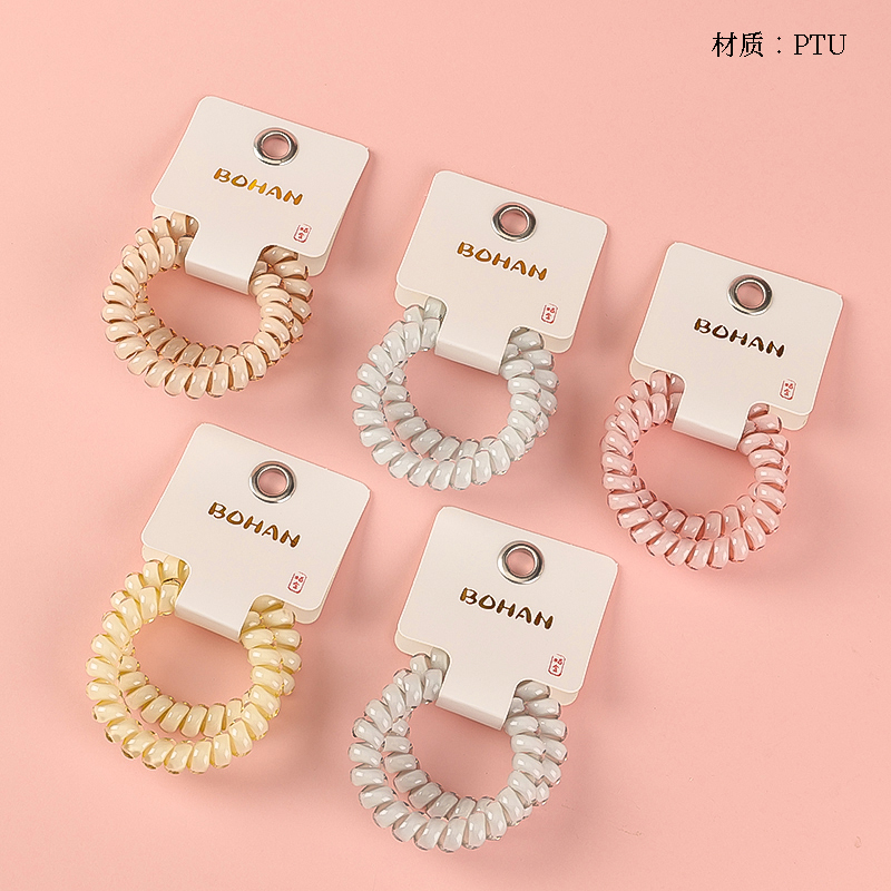 Boxed two cream-colored telephone cords