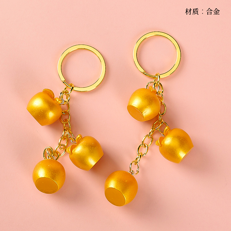 Three golden apple pendants