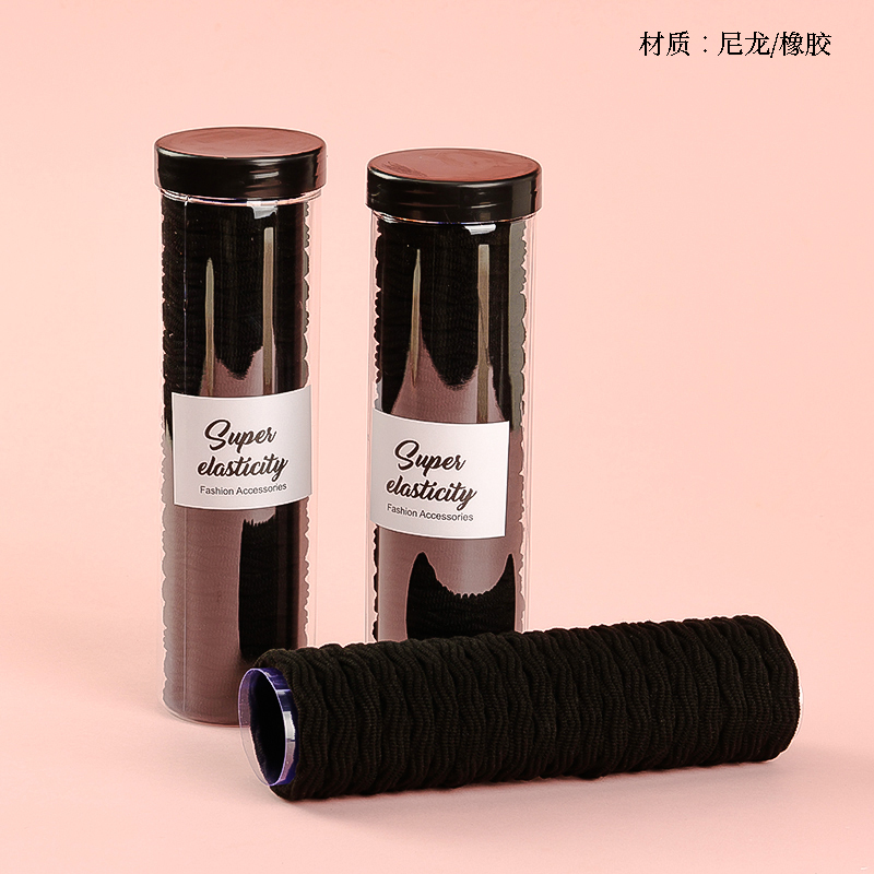 Twenty black jacquard rubber bands in a tube