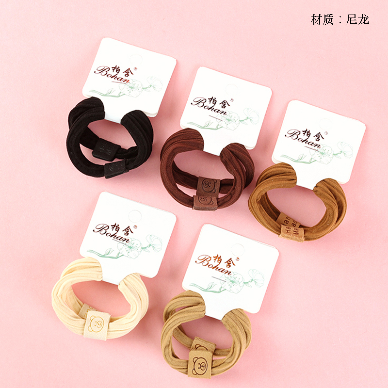 Boxed two curry-colored bear-labeled cotton rubber bands