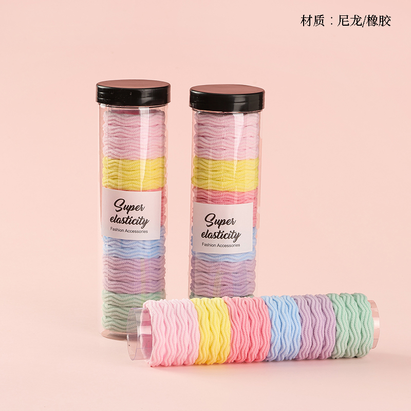 Twenty colored jacquard rubber bands in a tube