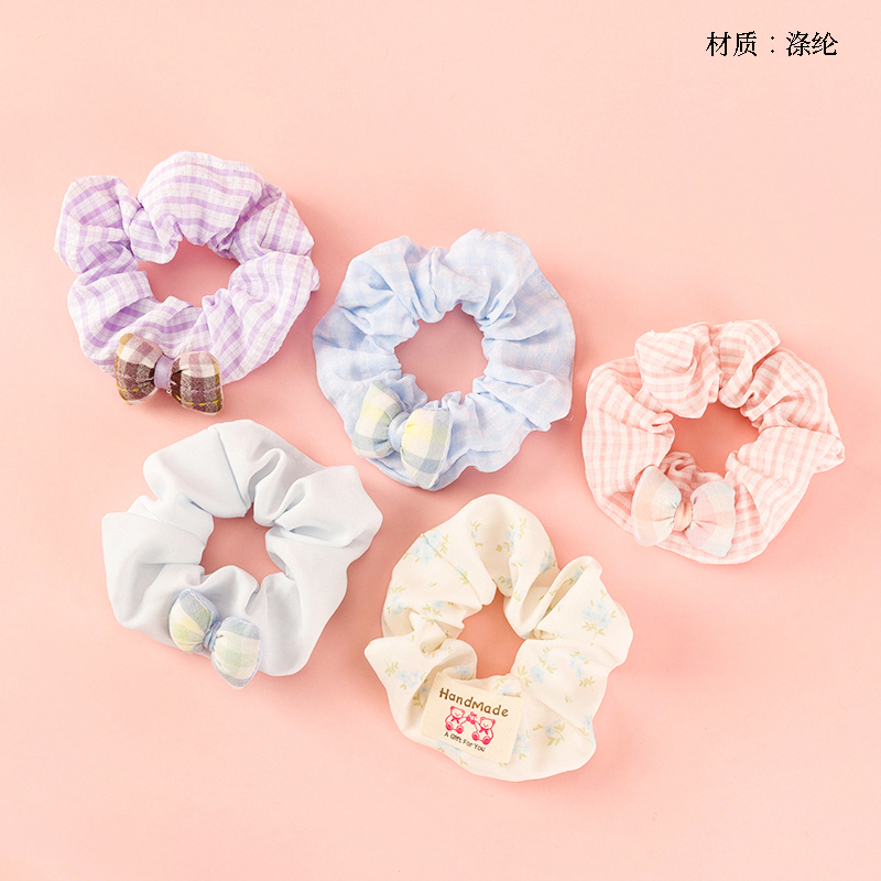 Boxed cotton-filled bow tie labeled large intestine ring